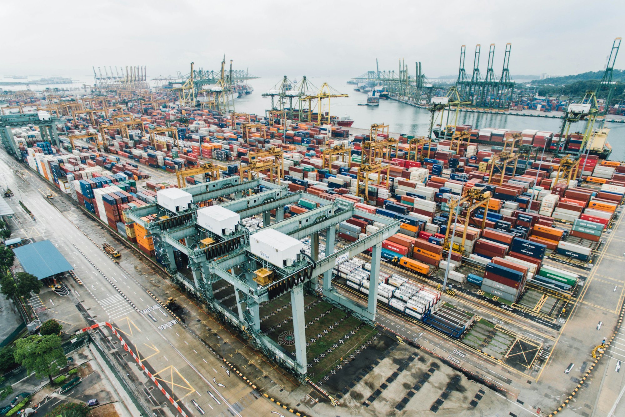 Aerial view of a container port with cranes and stacked containers